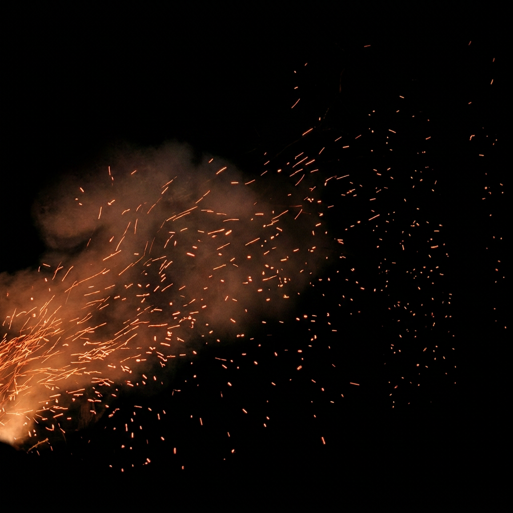 Nighttime wildfire with glowing sparks and smoke in forest